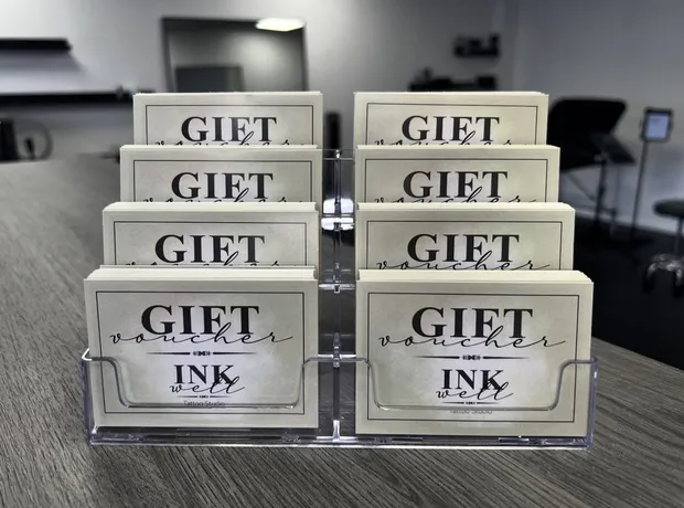 Inkwell gift voucher cards in a stand on the studio counter