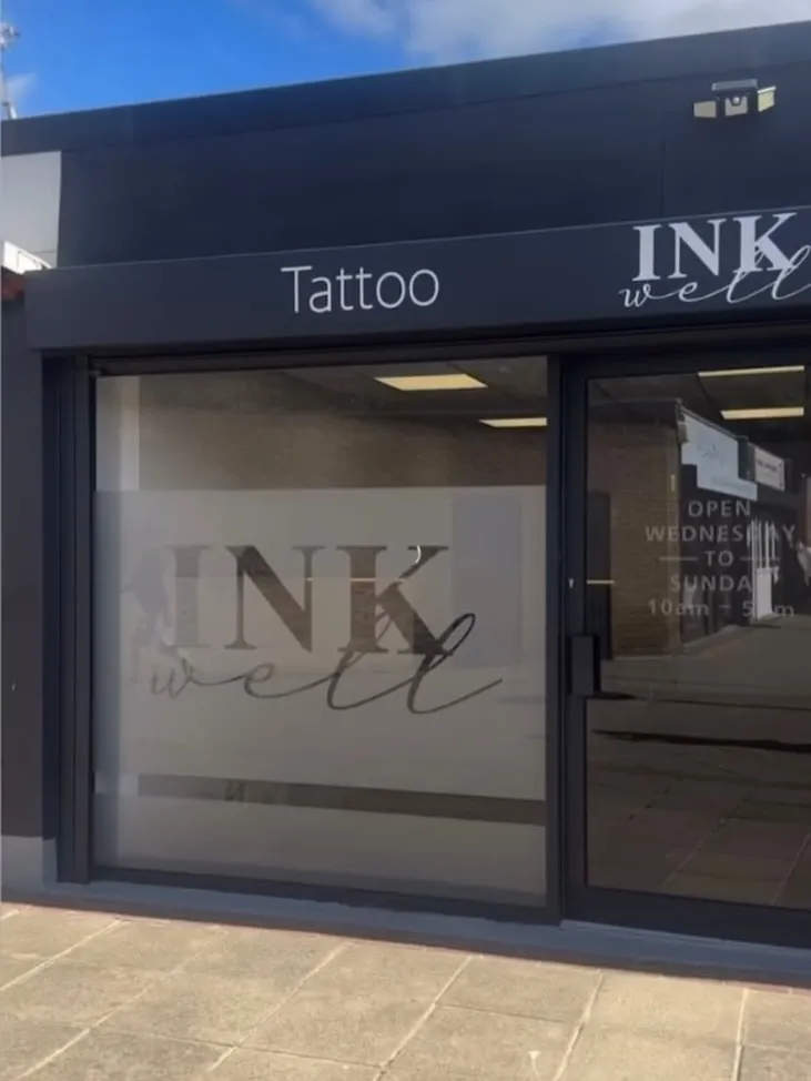 Inkwell Tattoo Studio’s charcoal shopfront with the Inkwell logo etched into the frosted glass, Blaydon Upper Precinct