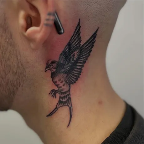 Finished: A swallow over an old neck tattoo, by Tabitha